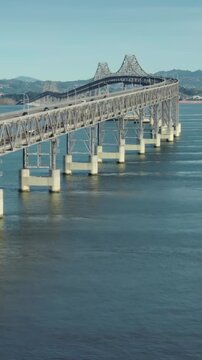 Cars and trucks travel across the Richmond-San Rafael Bridge, connecting Contra Costa and Marin counties in California, USA. San Quentin.