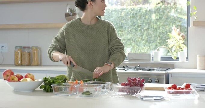 Diverse couple chopping vegetables at kitchen island after missing celery triggers partner handoff