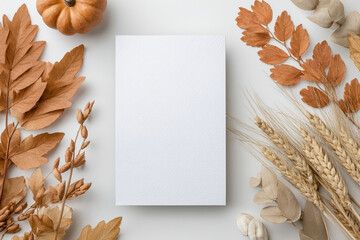 A blank card for Thanksgiving invitation mockup is centrally placed on a light surface, surrounded by various autumn decorations