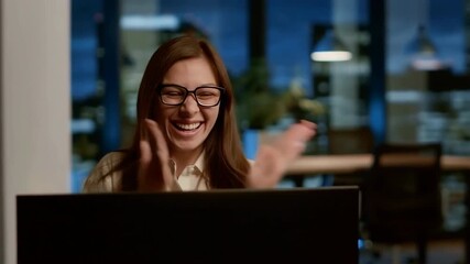 Woman, computer and happy reaction with applause for good news in office at night. Excited employee working late with success, achievement or online celebration for startup milestone or reward