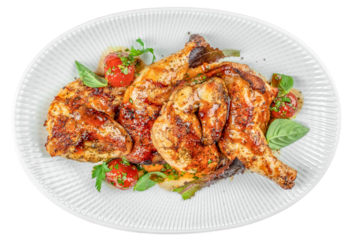 Grilled chicken quarters glazed with savory herbs and sauce, served with cherry tomatoes and fresh basil on a white plate isolated on white background. top view.