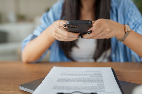 unknown woman scan or take a photo with mobile phone of document