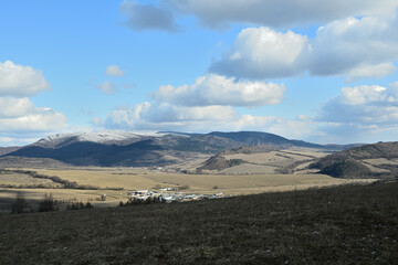 Landscape scenery blue sky, and hilltops in spring with little snow