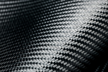 Horizontal photo of textured black carbon fiber panel