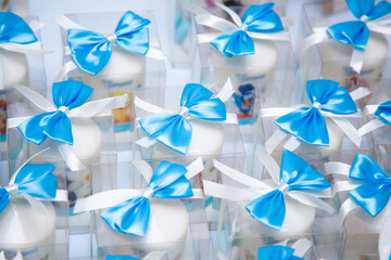 An assortment of candles beautifully adorned with blue bows on them