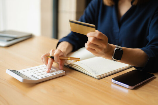 Businessman calculating monthly office expenses, taxes, bank account balance and credit card bills payment, Income is not enough for expenses in office.