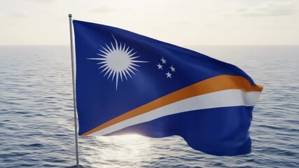 The flag of the Marshall Islands waves in the breeze. The flag is blue with white and orange stripes and a white star in the upper left corner.

