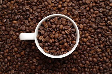 White Coffee Cup Filled with Roasted Coffee Beans