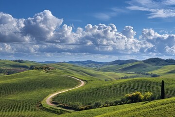 Winding road through rolling hills in Tuscany under sky with clouds, for travel blog