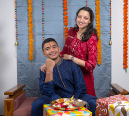 Loving brother and sister with gift box celebrating traditional Indian festival like Rakshabandhan...