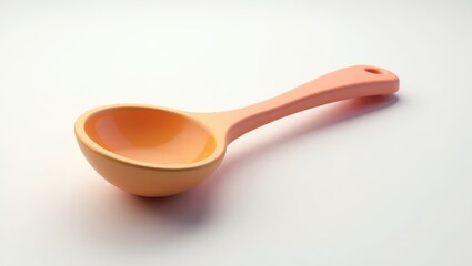 A peach-colored measuring spoon.