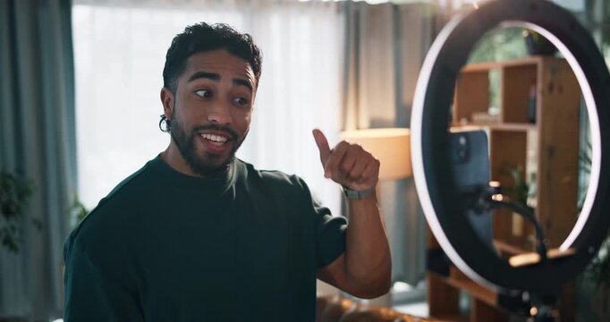Home, influencer and man with cellphone, ring light and excitement with social media. Followers, content creation and person with smartphone, recording and live streaming with app and subscription