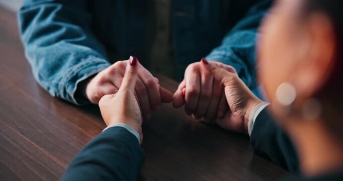 Holding hands, love and support with people in home together for grief counseling, loss or pain. Empathy, solidarity and trust with friends in apartment for bonding, confession or forgiveness