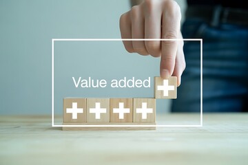 Hand adding wooden block with plus sign to row of blocks showing value added image