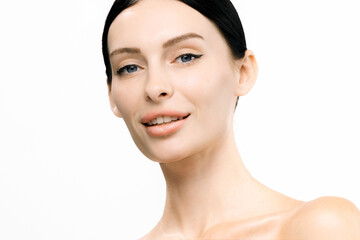 Close-up portrait of a smiling woman with clear skin and minimal makeup, showcasing natural beauty...