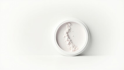 White cosmetic powder in a round container.