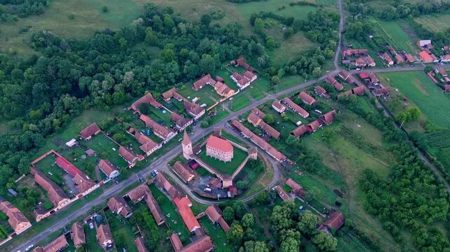 Aerial view of Crit village with the view at sunset. Transylvania village in Romania. Traditional village in the heart of Transylvania with old traditional houses and red roofs. Via Transilvanica 