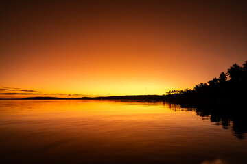 Stunning sunset casts golden hues over Moso island in Vanuatu © Groovy Banana