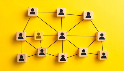 A network of interconnected wooden blocks, each bearing a person icon, arranged on a bright yellow surface
