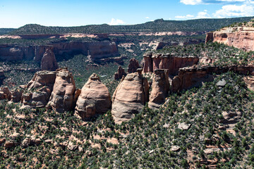 High angle panoramic view over Monument Canyon with pillars of the Coke Ovens along the Rimrock Drive on top of Colorado National Monument plateau near Grand Junction, Colorado, USA