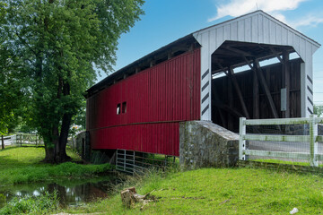 The historic 1962 built red colored Willow Hill Covered Bridge located off U.S. Route 30 spaning Miller’s Run in Lancaster County, PA, USA