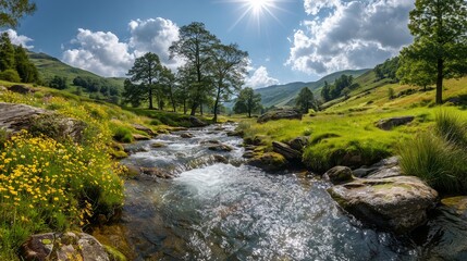 Sunlit mountain stream winding through vibrant green meadows dotted with yellow wildflowers under a bright blue sky