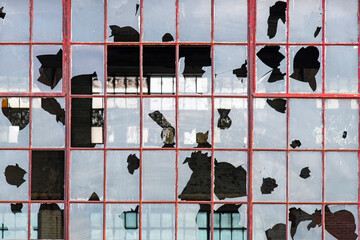 Close up view of large factory building window with broken glass in abandoned, dilapidated and old steel manufacturing plant in Bethlehem, Pennsylvania, USA