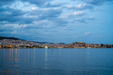 Fototapeta premium Coastal Town of Kavala at Twilight with Reflections on Water