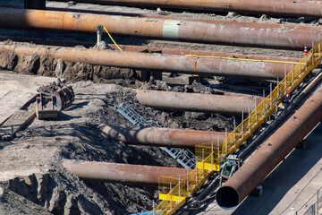 High angle view of large steel pipes for excavation pit shoring or supporting the sides of a...