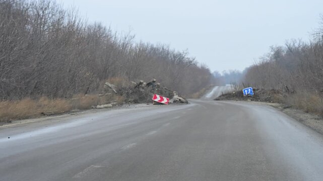 A point-of-view shot from a car driving past a makeshift military checkpoint on the outskirts of Kramatorsk, Ukraine. A common sight on roads near the frontline.