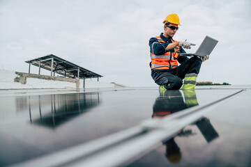 Technician monitors solar panels while sitting on a rooftop during a cloudy day in an urban area