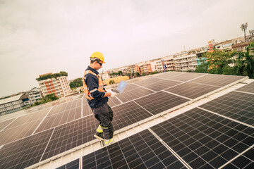 Technician works on solar panels on a rooftop in an urban setting during daylight hours