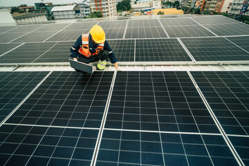 Technician performs maintenance on solar panels during sunny daytime in an urban location