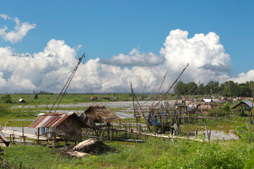 Local fishermen's riverside huts and nets for catching fish.