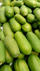 Fresh Green Papayas Stacked for Market Sale