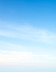 Naklejka premium Soft Sky Background with Light Blue Gradients: Wispy Clouds & Subtle Sunrise Hues, Perfect for tranquil, serene backdrops, copy space, banners & graphic design