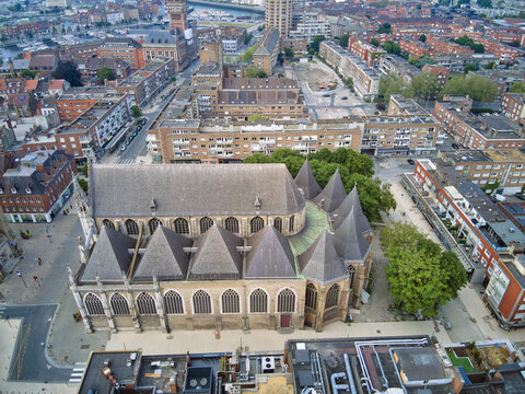 Aerial view of Saint-&Atilde;&permil;loi Church's dark stone contrasts with the surrounding red-brick buildings under a soft, diffused light, Dunkirk, France.