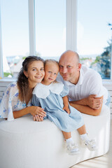 Family enjoys a cheerful moment together in a bright room by the window