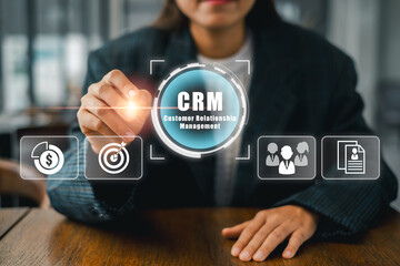 Businesswoman using CRM technology interface for effective customer relationship management in a modern office environment.