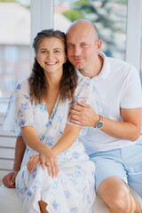 Couple enjoying a moment together in a sunny indoor setting with bright natural light