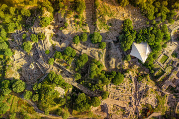 Drone capturing the archaeological site of Troy in Turkiye, highlighting the ancient theater amidst...