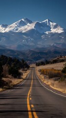 Fototapeta premium Snow-capped mountains under clear blue sky.