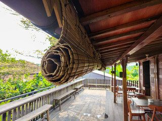 Rolled Bamboo Blind Hanging on Traditional Wooden House Terrace