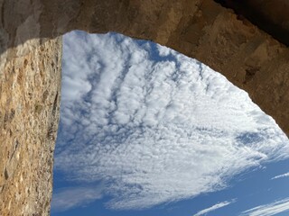 View of the sky from an ancient stone arch