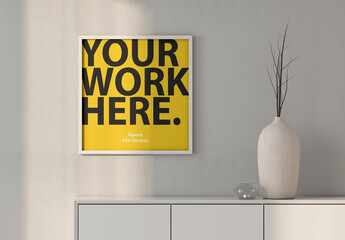 Square poster Art Frame Mockup hanging on wall
