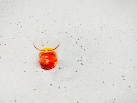orange solution in a beaker glass