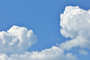 Fluffy white clouds drifting across a bright blue sky.
Concept of: Natural beauty.