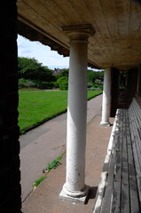 Pillars and benches of a shelter on the cliffs of Cromer against a blue sky in summer