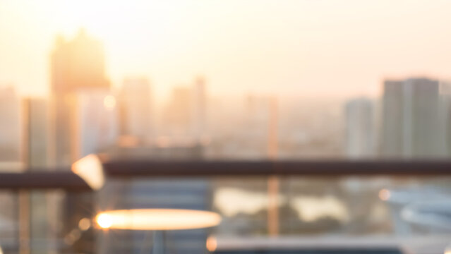 Summer sun blur golden hour sky sunset with city rooftop view  background cityscape office building landscape blurry urban lights skyline bokeh for evening party