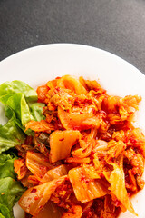 Kimchi pickled cabbage salad spicy savory vegetables fresh delicious gourmet food background on the table rustic food top view copy space vegetarian and vegan food